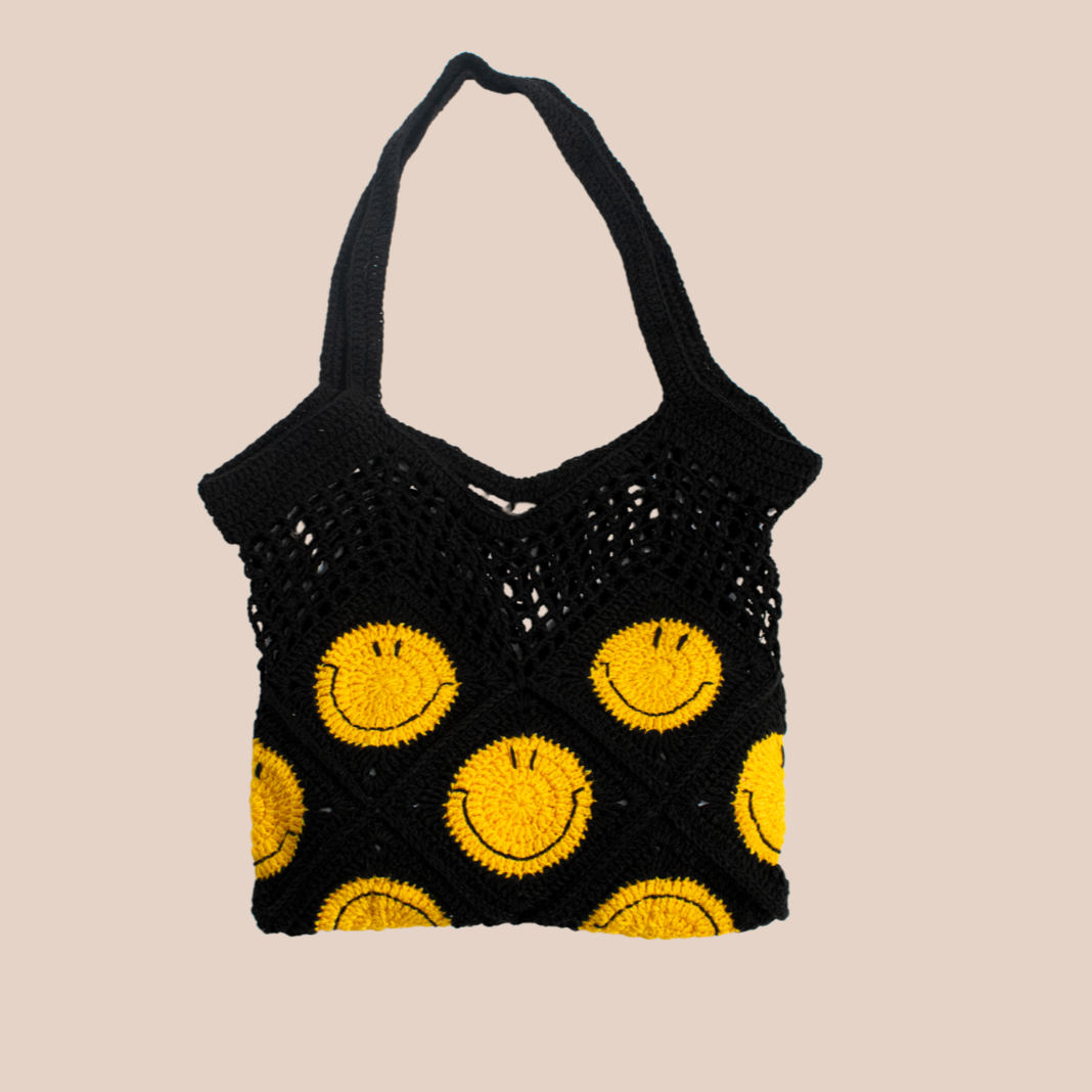 Hand-crocheted black cotton bag.
Two large cotton handles and yellow smiley patterns.