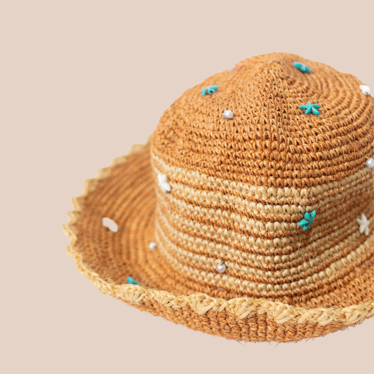 Handmade hat crafted from untreated cactus fibers, adorned with blue starfish-shaped beads.