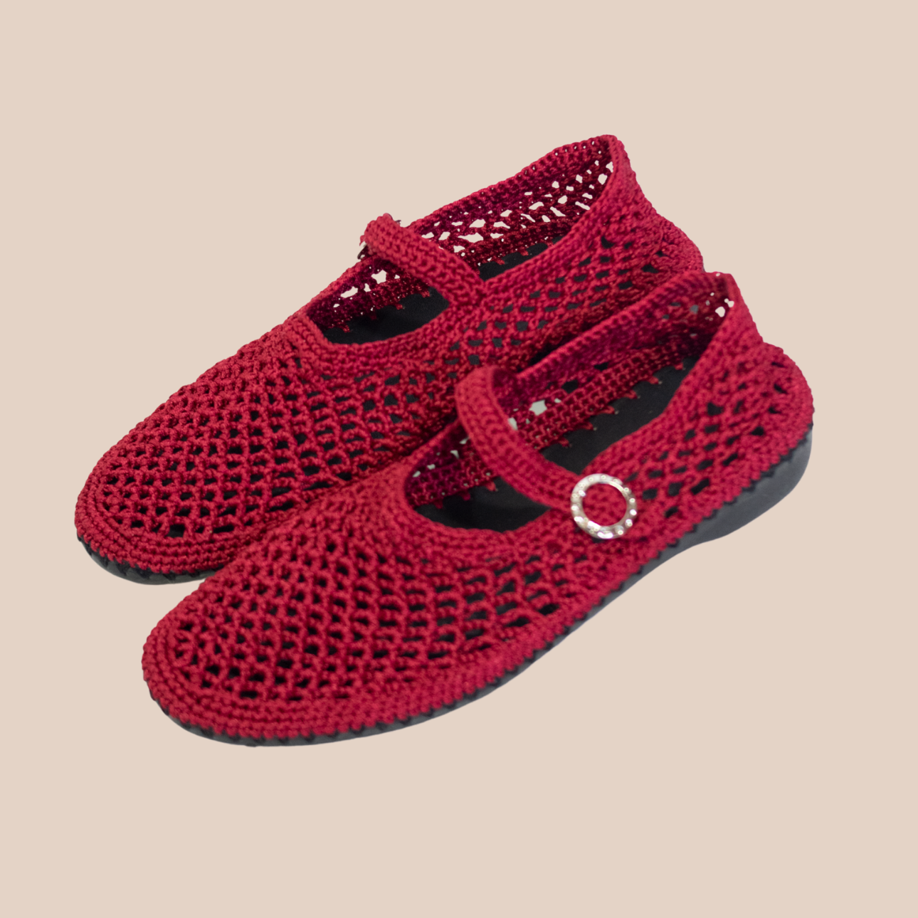 Red ballerina flats with a hand-crocheted waxed thread mesh design. Buckle closure and rubber sole.