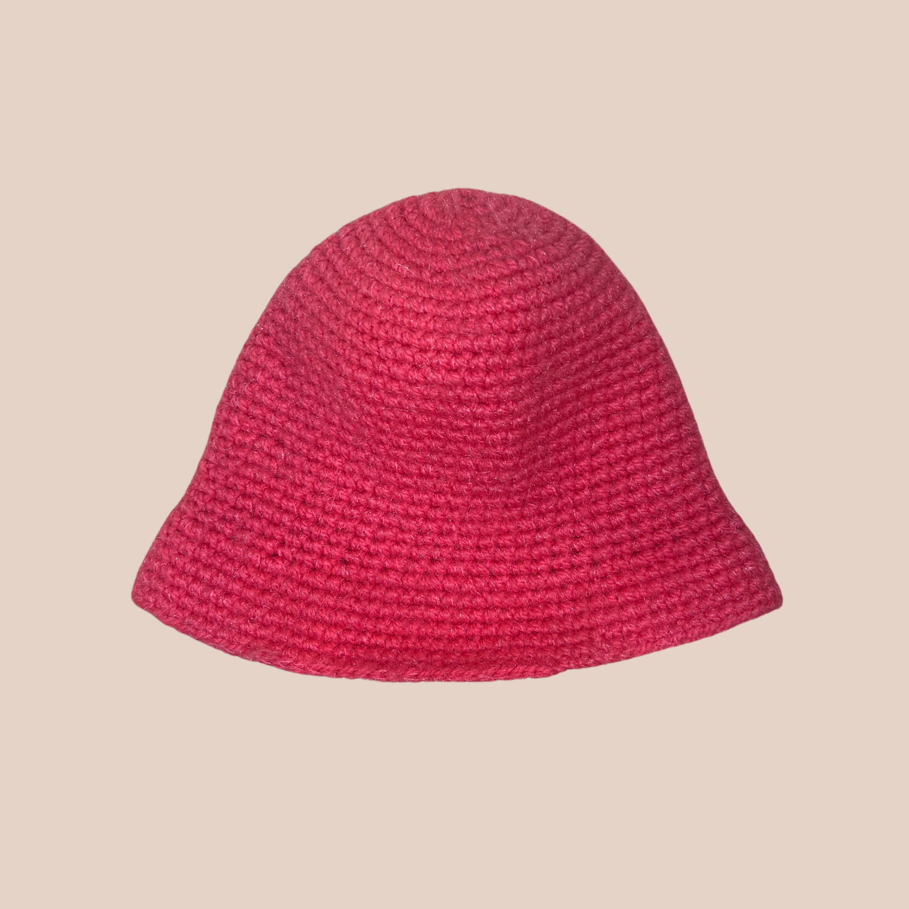 Un bucket hat crocheté en laine et acrylique, arborant un rose vif et audacieux