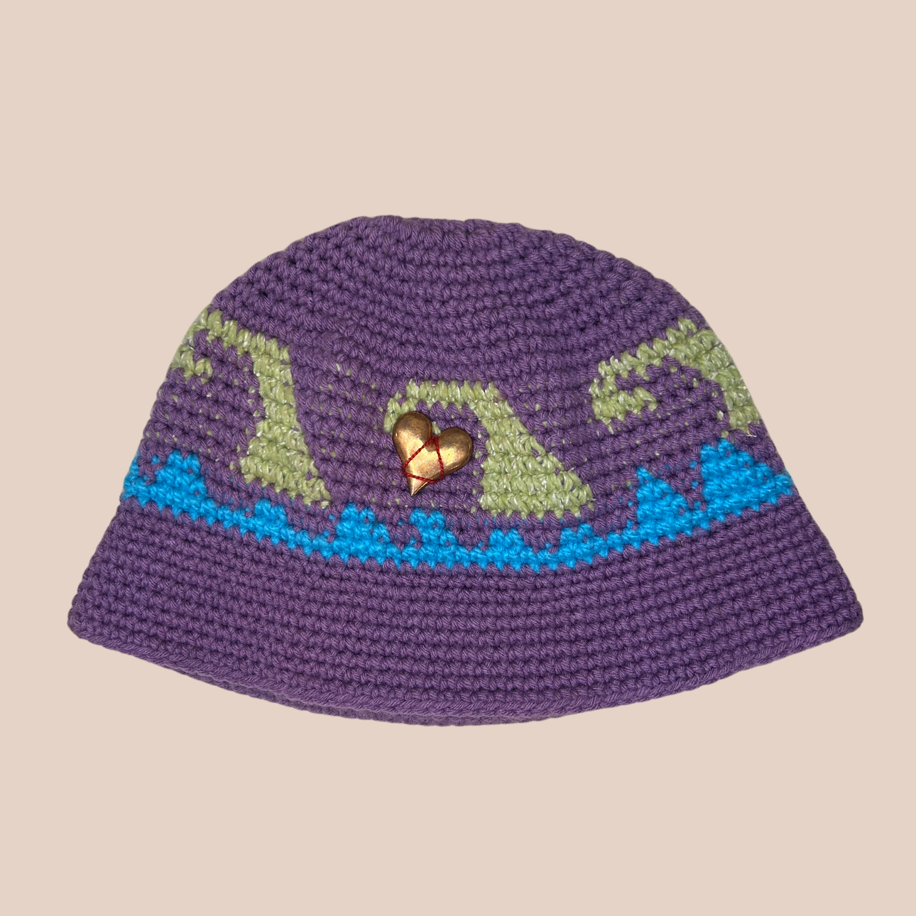 Image d'un bucket hat crocheté en laine et acrylique decoration coeur cousue main de Maison Badigo, arborant des couleurs vives et audacieuses
