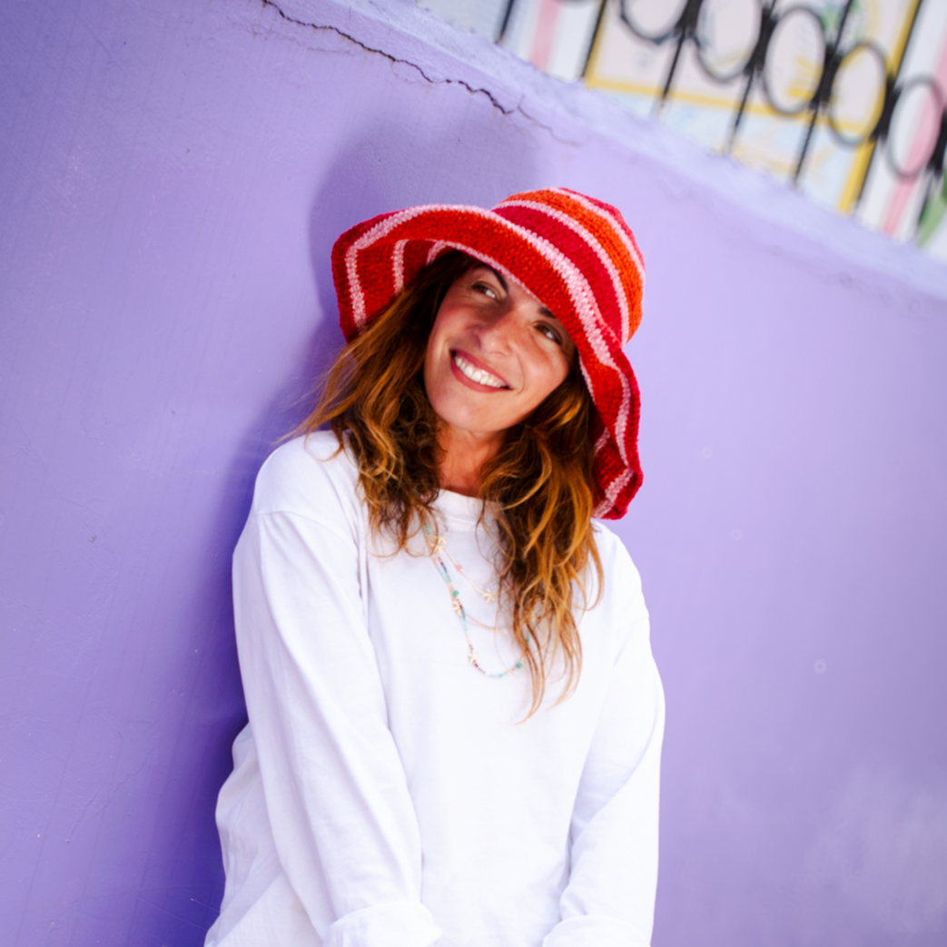 Handmade wide-brim chenille (cotton silk) crochet hat with striped patterns in shades of orange.