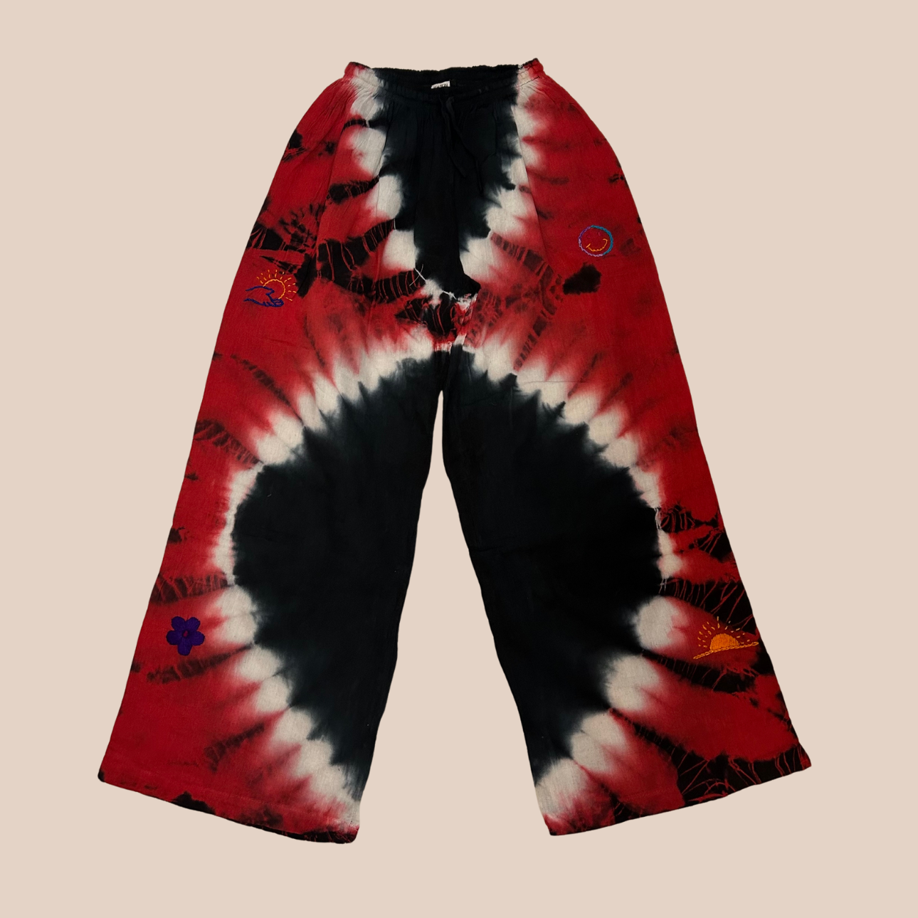 Image du pantalon large tie & dye rouge et noir, un pantalon large aux nuances vibrantes de rouge et de noir, un véritable tourbillon de couleur et de style