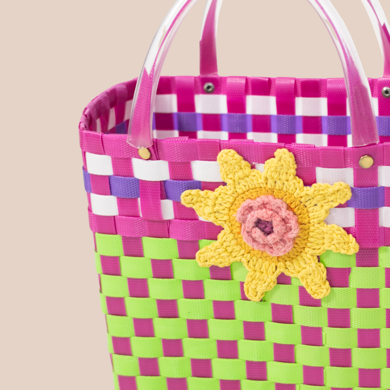 Handmade recycled plastic bag in black and pink, featuring a large sunflower crocheted.